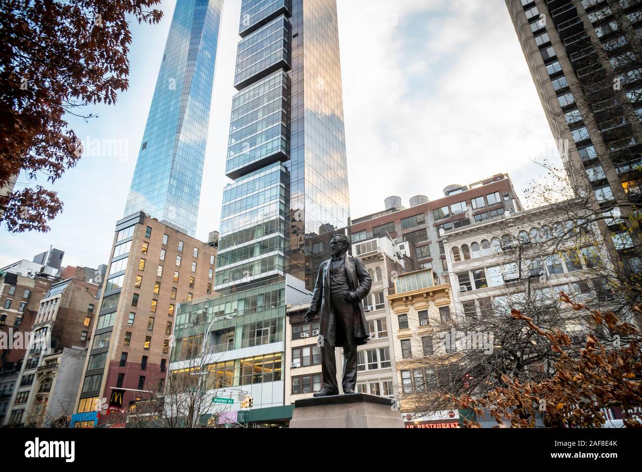 Statue of politician Roscoe Conkling with development behind it in Madison Square Park in the Flatiron neighborhood in New York on Thursday, December 5, 2019. The sculpture is by John Quincy Adams Ward and dates to 1893.  (© Richard B. Levine) Stock Photo