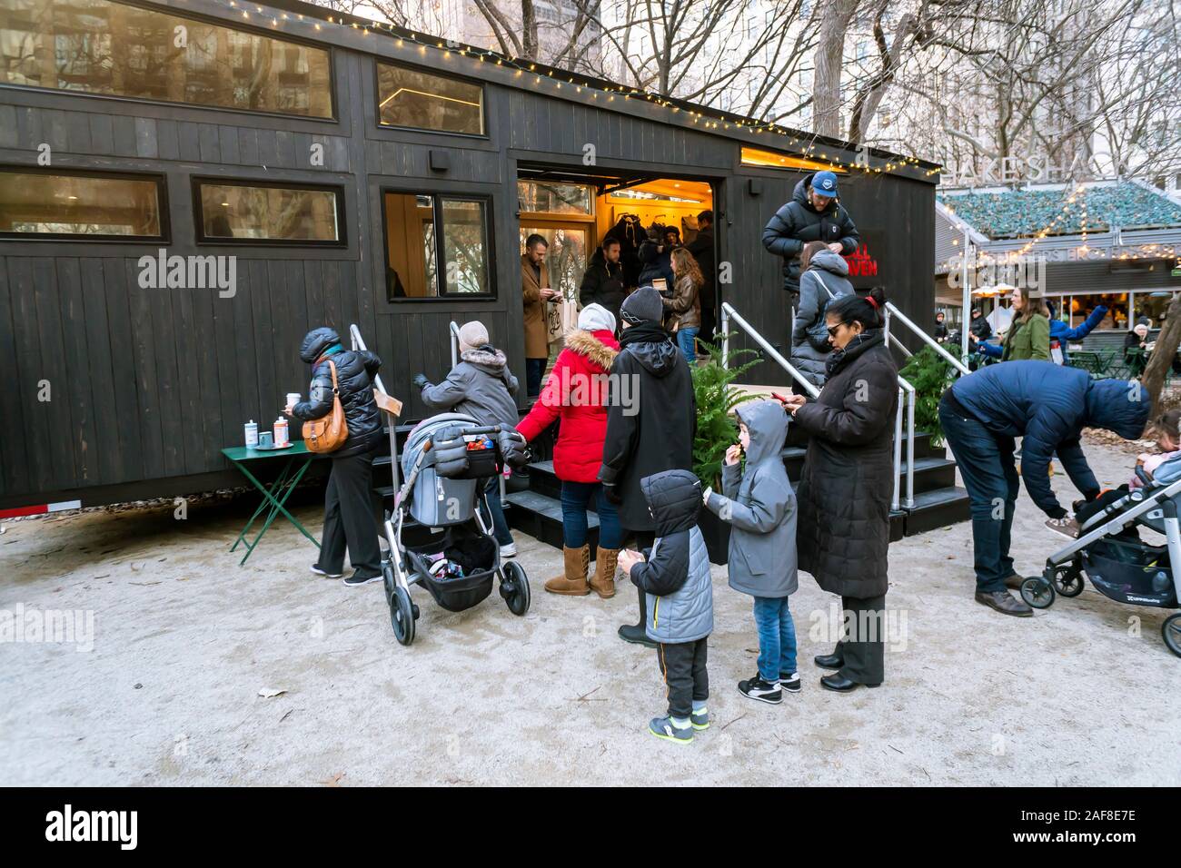 Visitors to the Madison Square Park tree lighting in New York on Thursday, December 5, 2019 enjoy the hospitality of hot chocolate from Fjällräven in their tiny house branding event. The outdoor equipment manufacturer sponsored the tree lighting and is owned by Fenix Outdoor which owns other brands including Royal Robbins. (© Richard B. Levine) Stock Photo