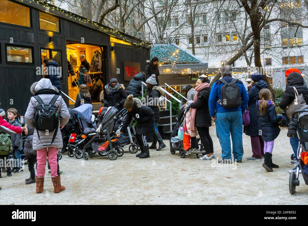 Visitors to the Madison Square Park tree lighting in New York on Thursday, December 5, 2019 enjoy the hospitality of hot chocolate from Fjällräven in their tiny house branding event. The outdoor equipment manufacturer sponsored the tree lighting and is owned by Fenix Outdoor which owns other brands including Royal Robbins. (© Richard B. Levine) Stock Photo