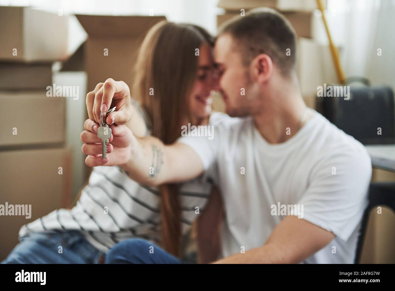 Holds keys of their new house. Successful people. Cheerful young couple ...