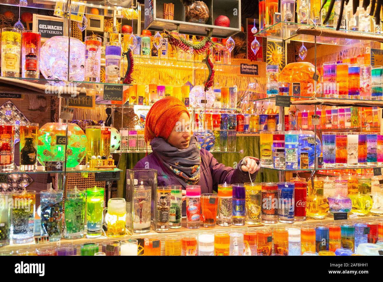 Europe Christmas markets; a colourful candle stall and market trader at the Rathaus Vienna Chjristmas market, Rathausplatz, Vienna Austria Stock Photo