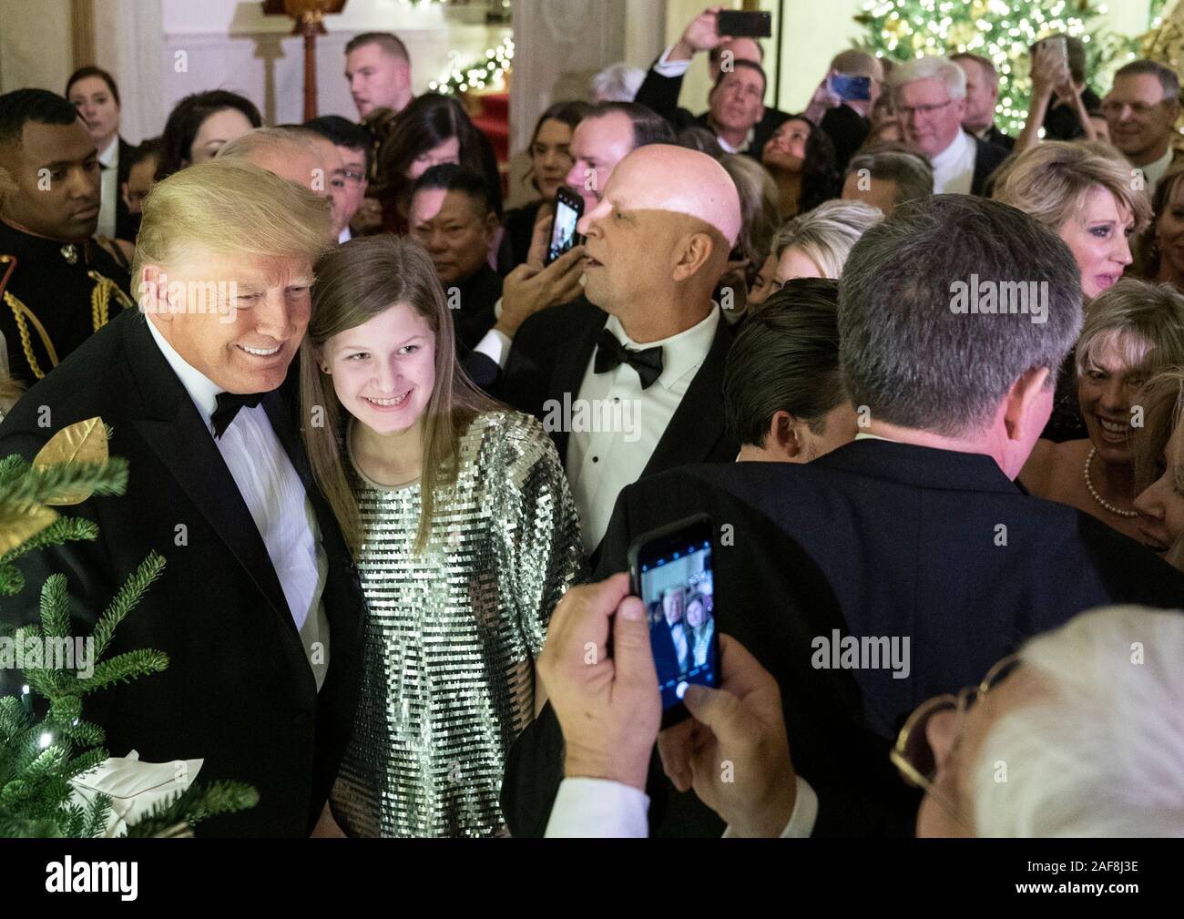 Washington DC, USA. 12 December, 2019. U.S President Donald Trump poses for photos with guests during the Congressional Ball in the Grand Foyer of the White House December 12, 2019 in Washington, DC.  Credit: Joyce Boghosian/White House Photo/Alamy Live News Stock Photo
