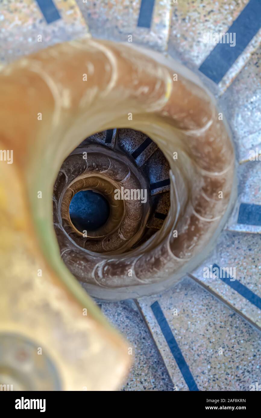 Top view to the stone spiral stairs, leading underground. Stock Photo