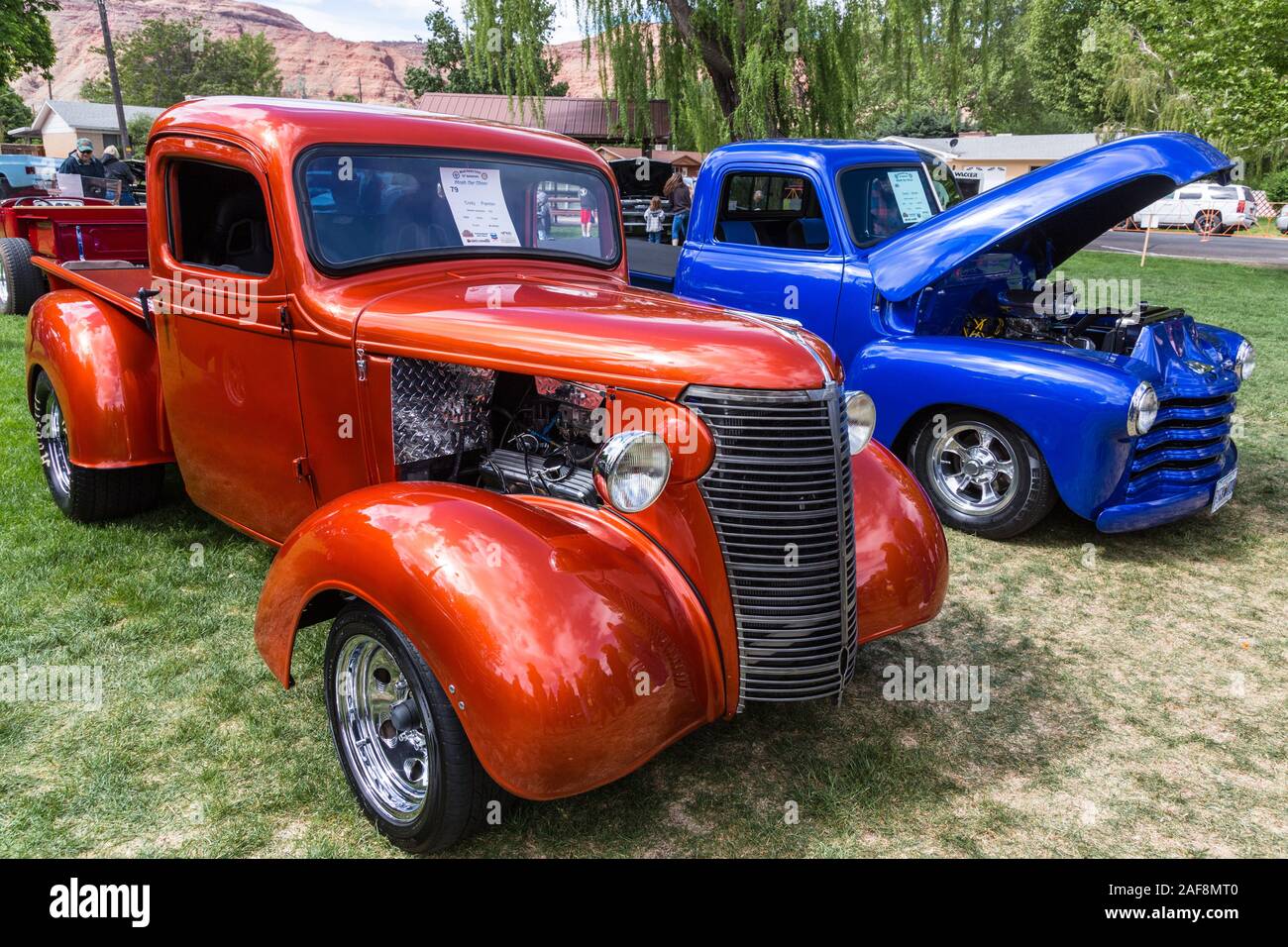 A restored and modified 1938 Chevy Pickup Truck in the Moab April Action Car Show in Moab, Utah.  Next to it is a blue 1951 Chevy 3100 Pickup Truck. Stock Photo