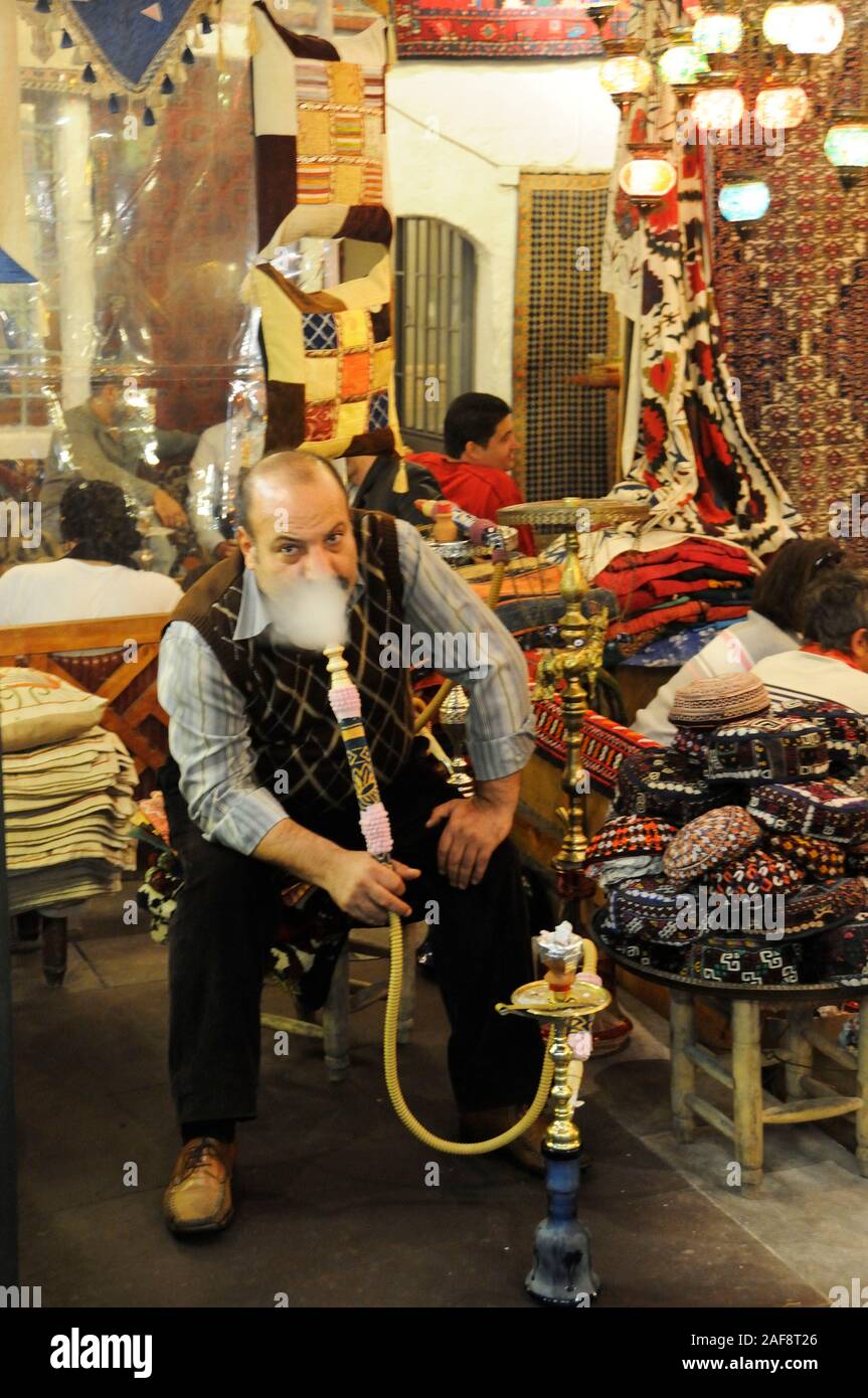 Man smoking nargileh and taking tea at Çorlulu Alipasa Medresesi. Istanbul, Turkey Stock Photo