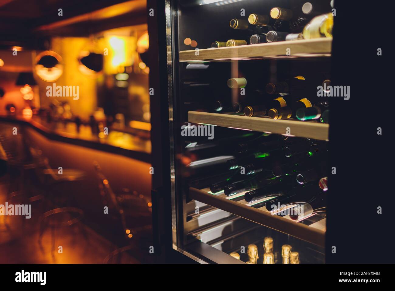 Storing bottles of wine in fridge. Alcoholic card in restaurant