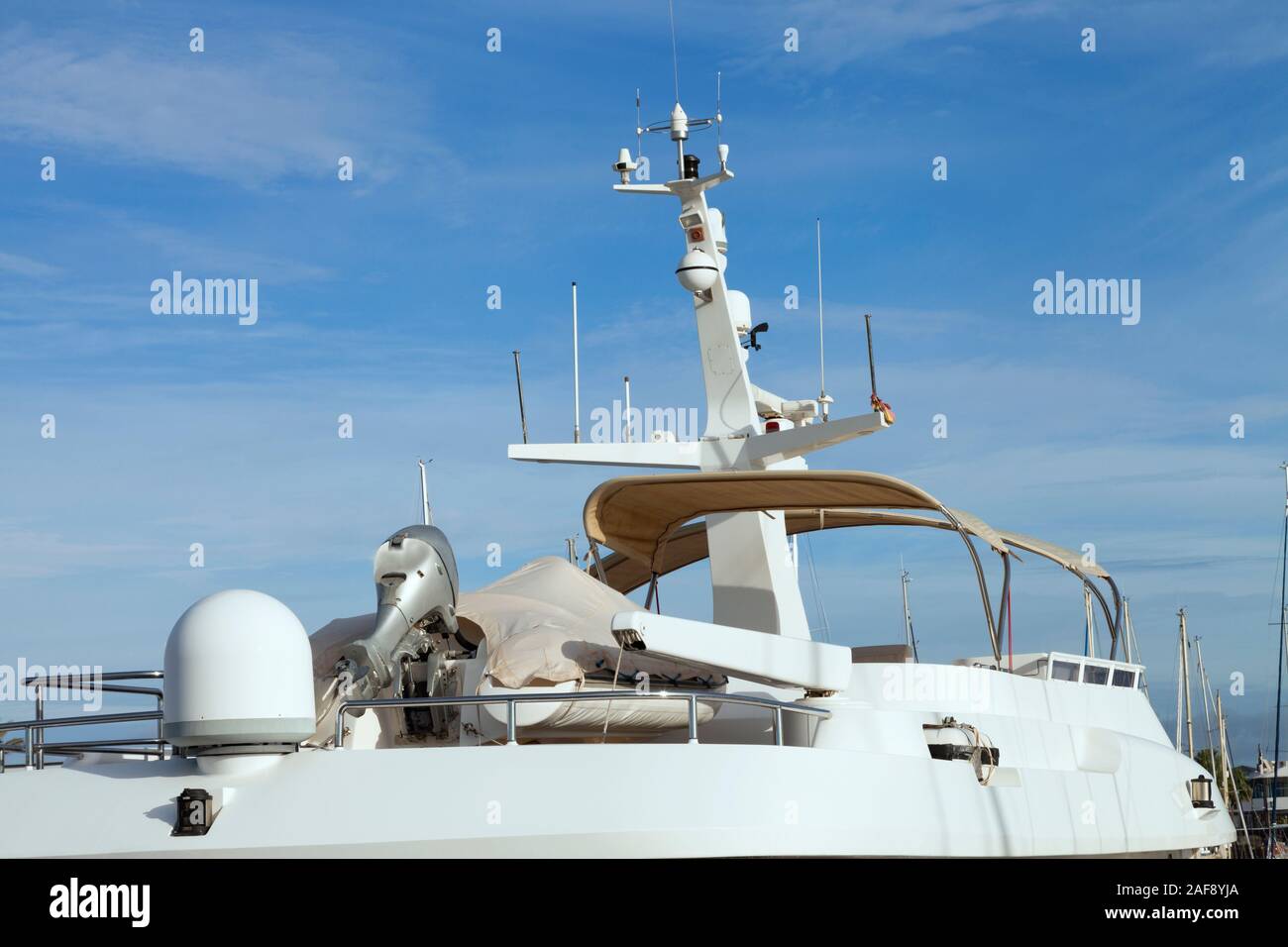 Top of super yacht with radar, antenna against blue sky . Stock Photo