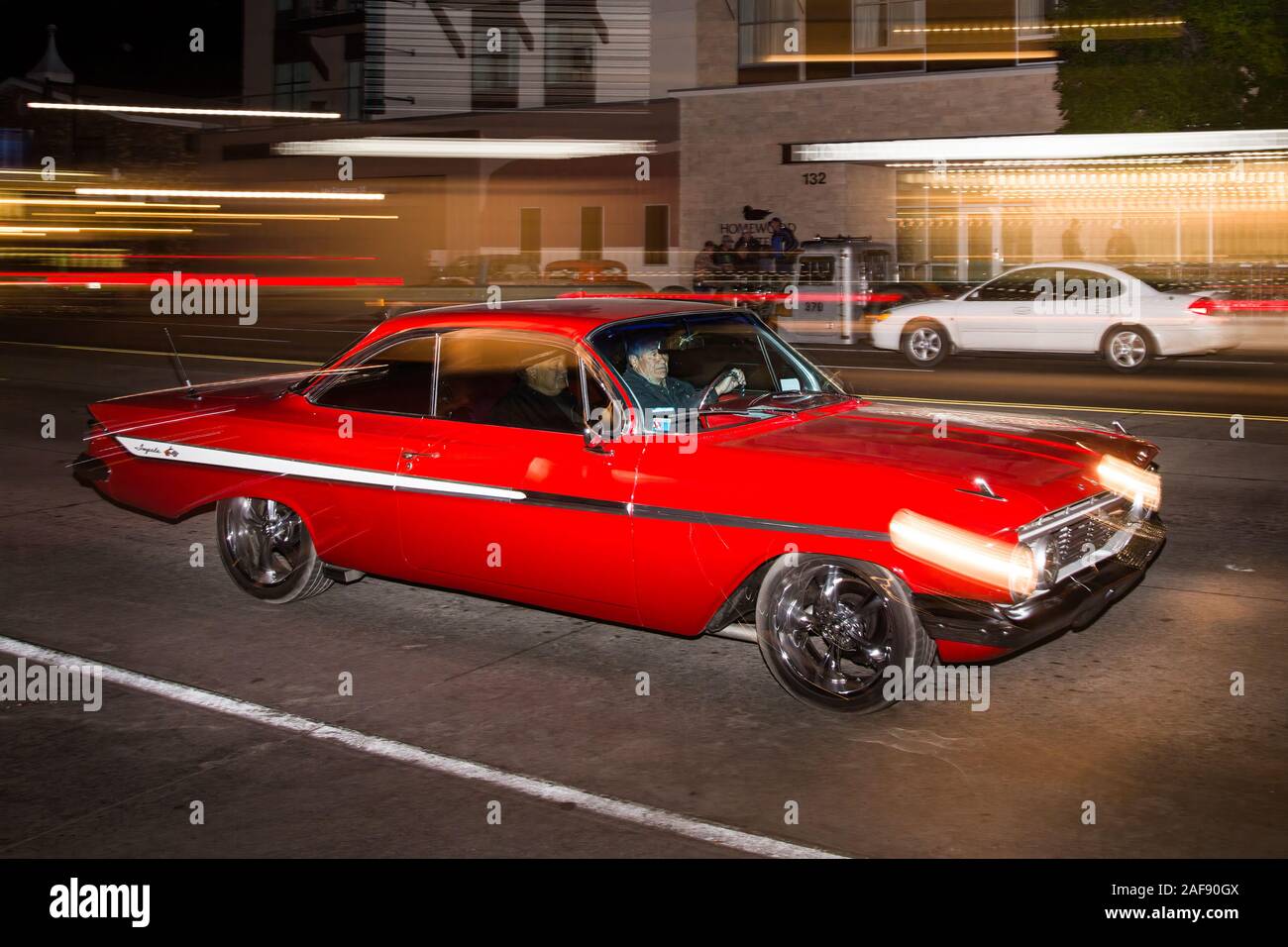 A restored 1961 Chevrolet Impala cruising in the Moab April Action Car