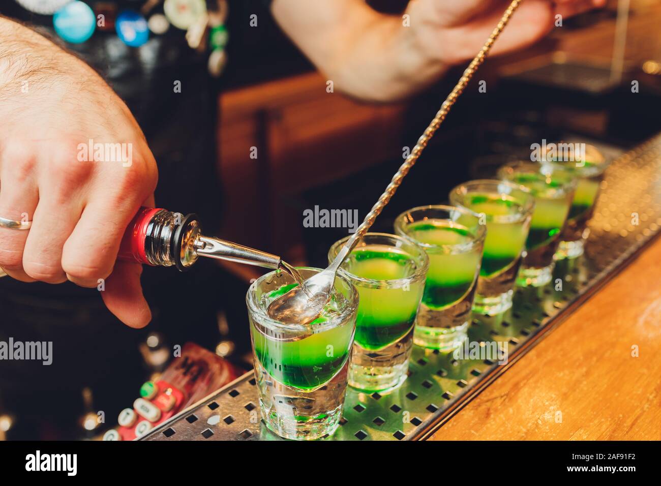 Barman make alcoholic shots with rum and liquor Stock Photo Alamy
