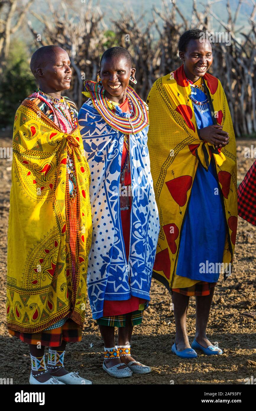 Tanzania. Maasai Village of Ololosokwan, Northern Serengeti.  Women Villagers Wearing Traditional Dress. Stock Photo
