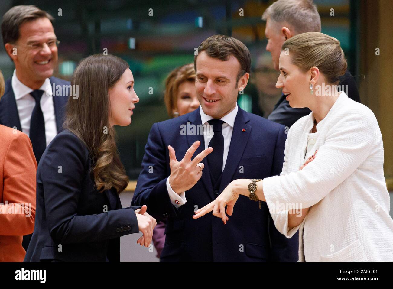 Brussels, Belgum. 12 December 2019. Finnish Prime Minister Sanna Marin  talks to the President of France Emmanuel Macron and Danish Prime Minister Met Stock Photo
