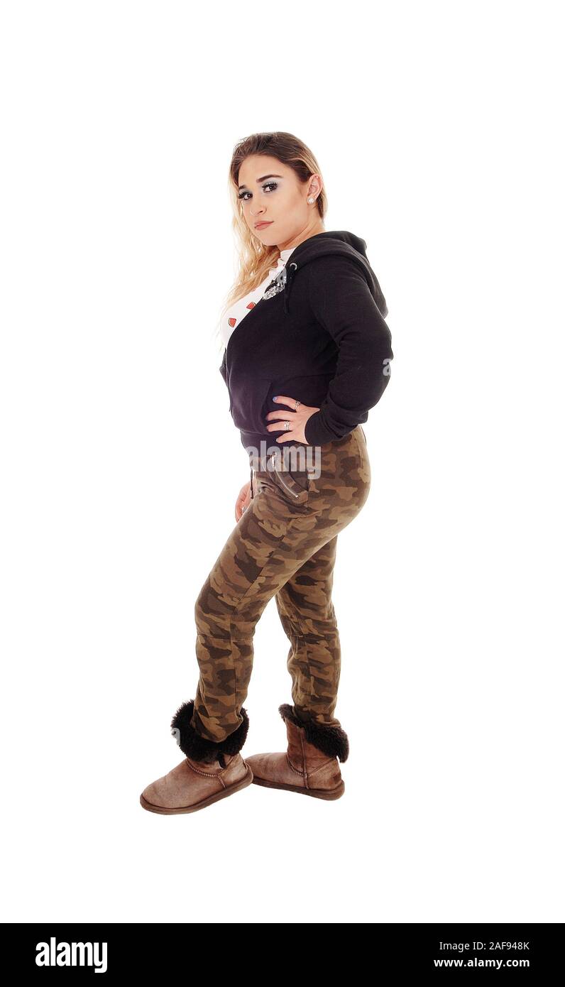 A young beautiful woman standing in camouflage pants and a black sweater and boots isolated for white background Stock Photo