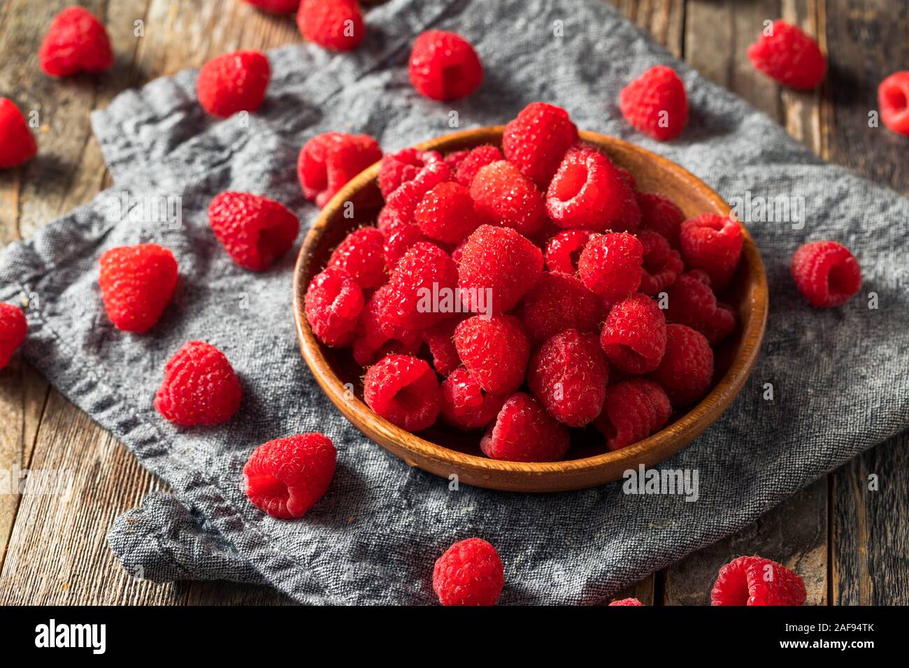 Raw Red Organic Raspberries in a Bowl Stock Photo