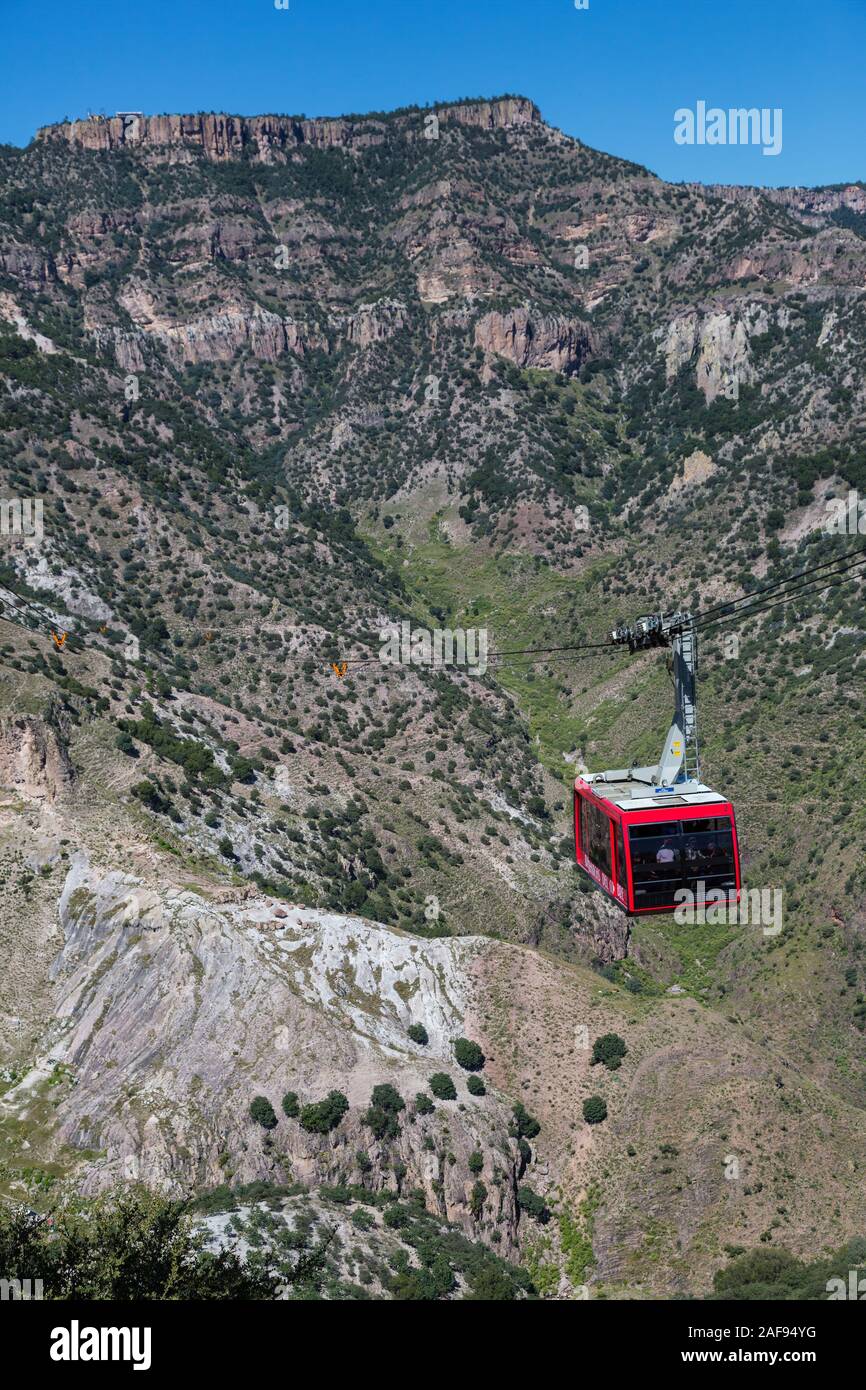 Divisadero, Copper Canyon, Chihuahua, Mexico.  Aerial Gondola en Route over Copper Canyon. Docking Station at top of Cliff. Stock Photo
