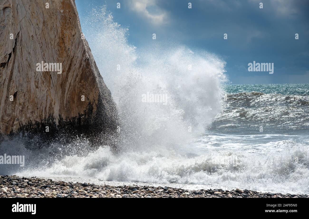 Rocky seashore with wavy ocean and waves crashing on the rocks Aphrodite Rock Paphos area, Cyprus Stock Photo