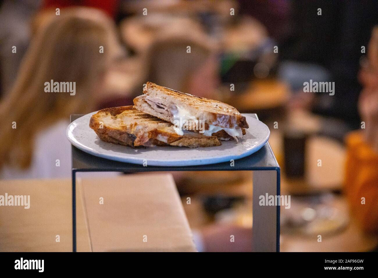 Sándwich mixto de jamón cocido a baja temperatura casero y queso pasiego, Pork and cheese panini at Mision Cafe, Madrid, Spain Stock Photo