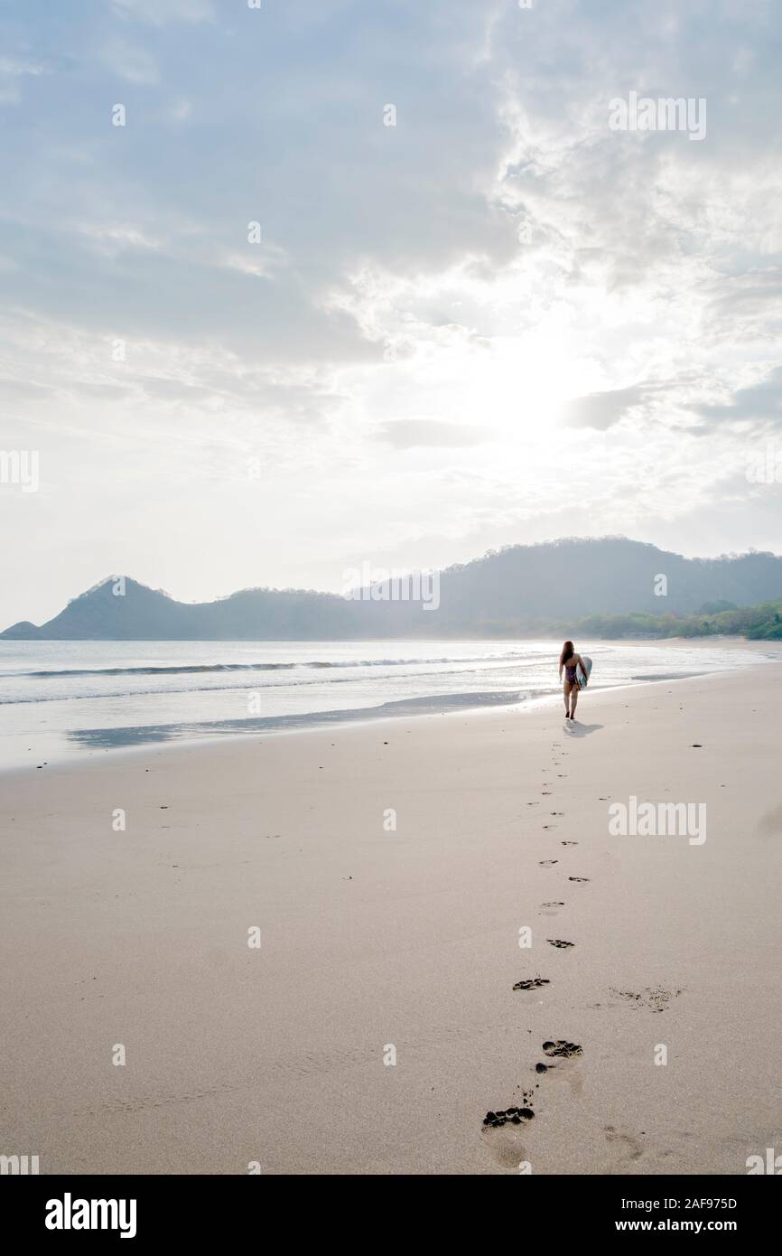 A solo surfer on Ocotal beach, San Juan del Sur, Nicaragua Stock Photo