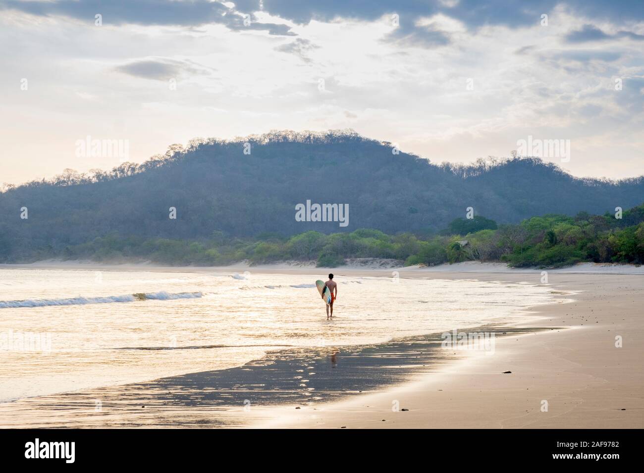 A solo surfer on Ocotal beach, San Juan del Sur, Nicaragua Stock Photo