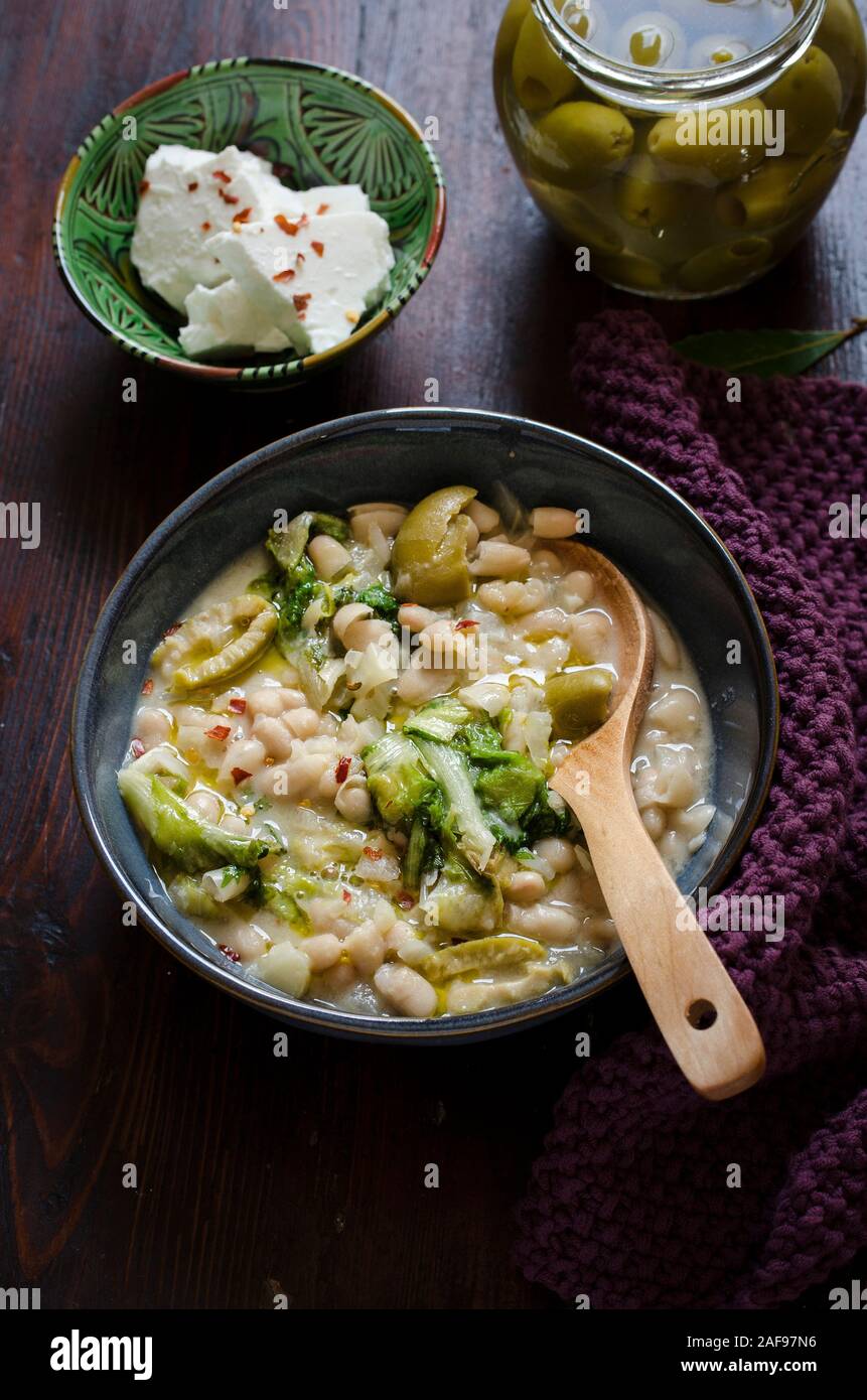 Navy bean and escarole stew with feta and olives Stock Photo