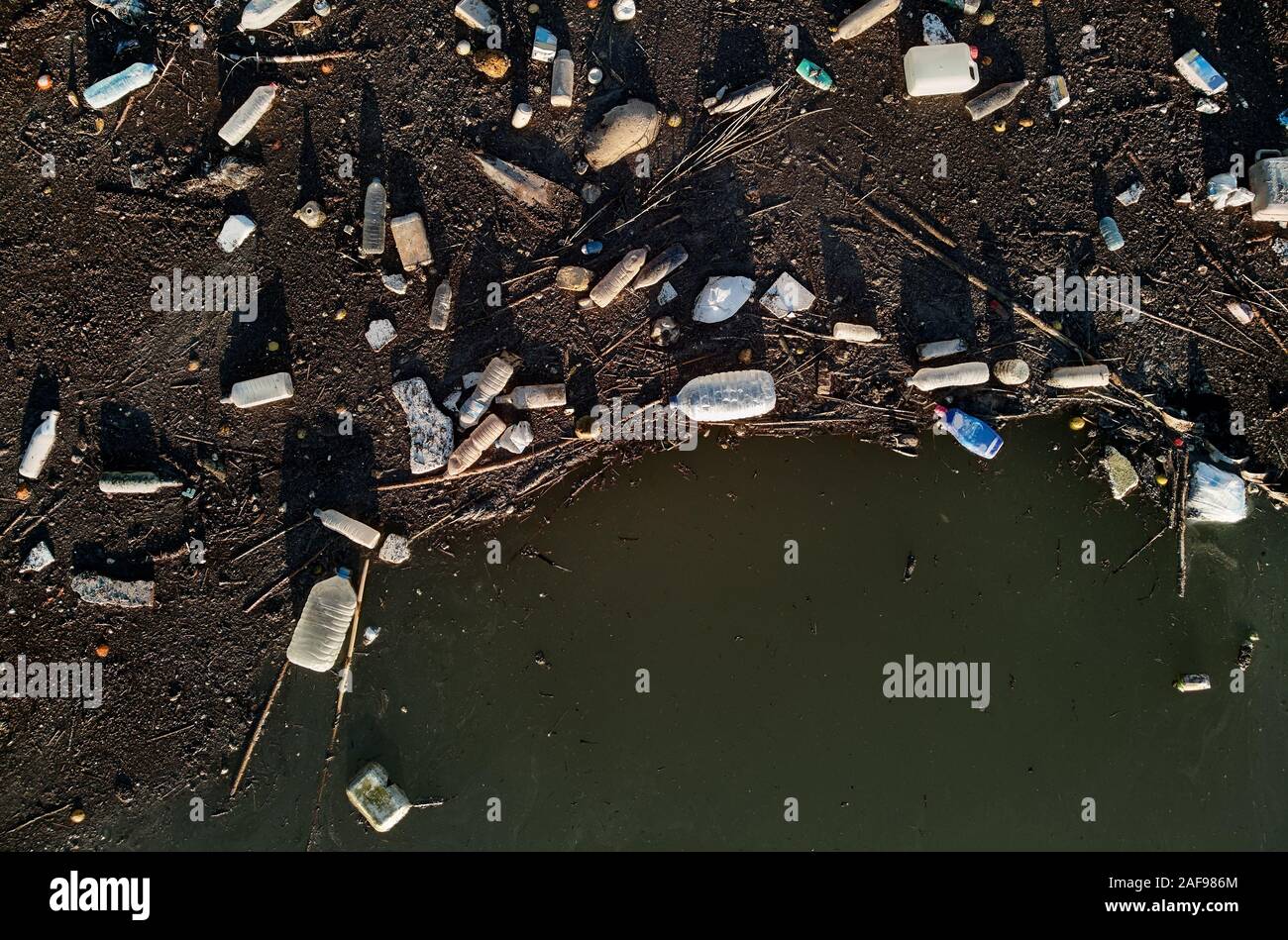 Aerial drone view waterfront scrap-heap plastic bottles rubbish pollution marine debris outdoors, environmental ecological natural disaster concept Stock Photo