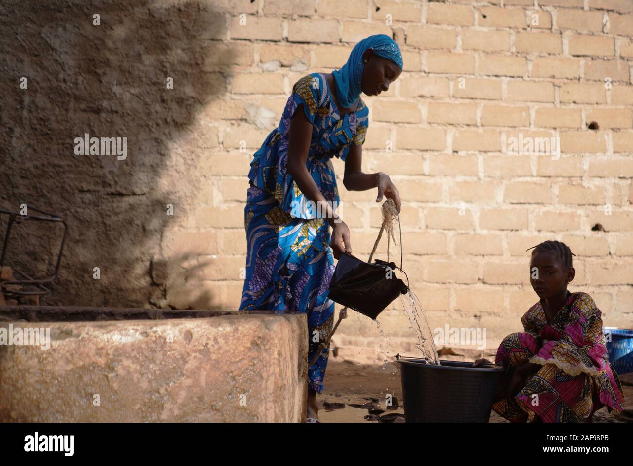 Girl Pouring Water African High Resolution Stock Photography and Images ...