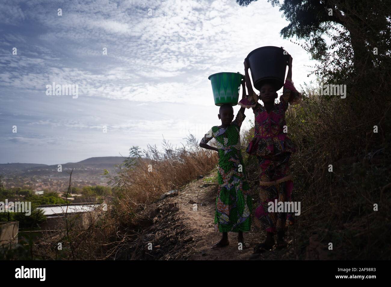 Little African Girls Walking with Heavy Water Buckets Stock Photo Alamy