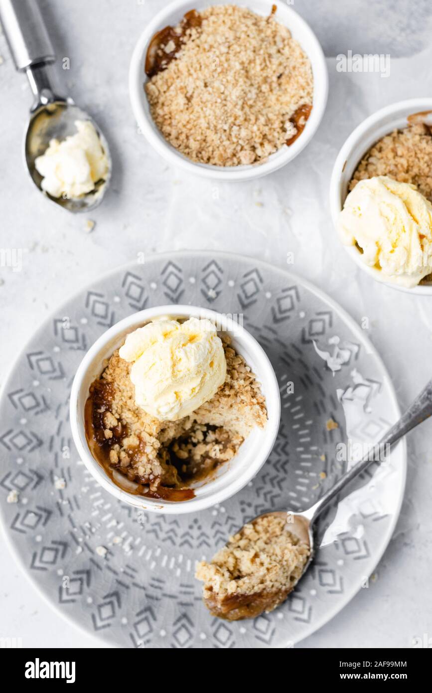 Rhubarb And Ginger Crumble Mini Pots With Vanilla Ice Cream Stock Photo