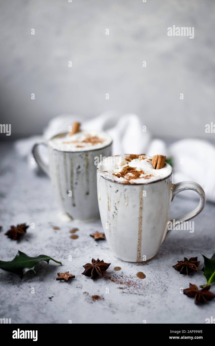 Pumpkin Spiced Latte With Whipped Cream Topping And Cinnamon Dusting Surrounded By Leaves And Spices Stock Photo