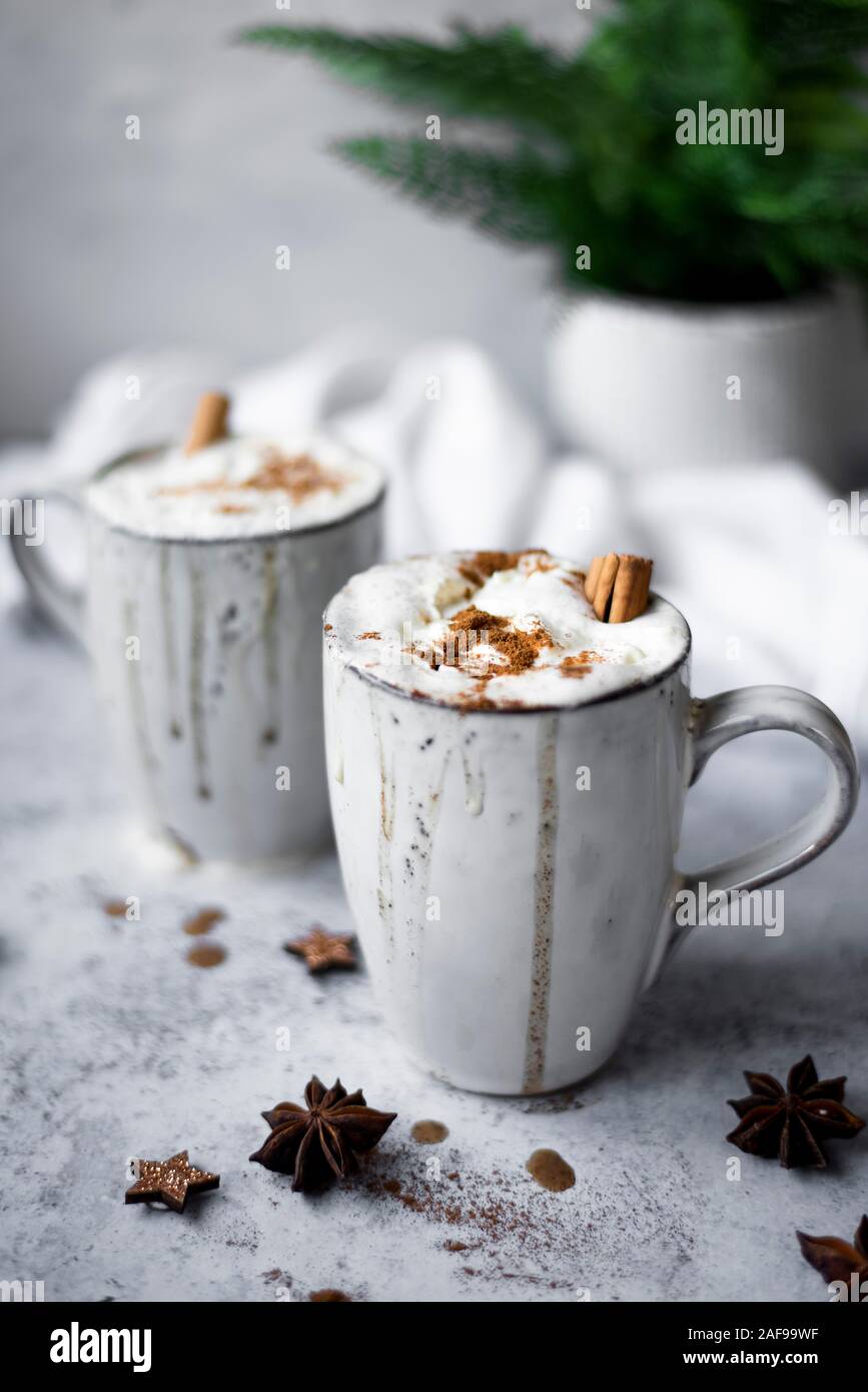 Pumpkin Spiced Latte With Whipped Cream Topping And Cinnamon Dusting Surrounded By Leaves And Spices Stock Photo