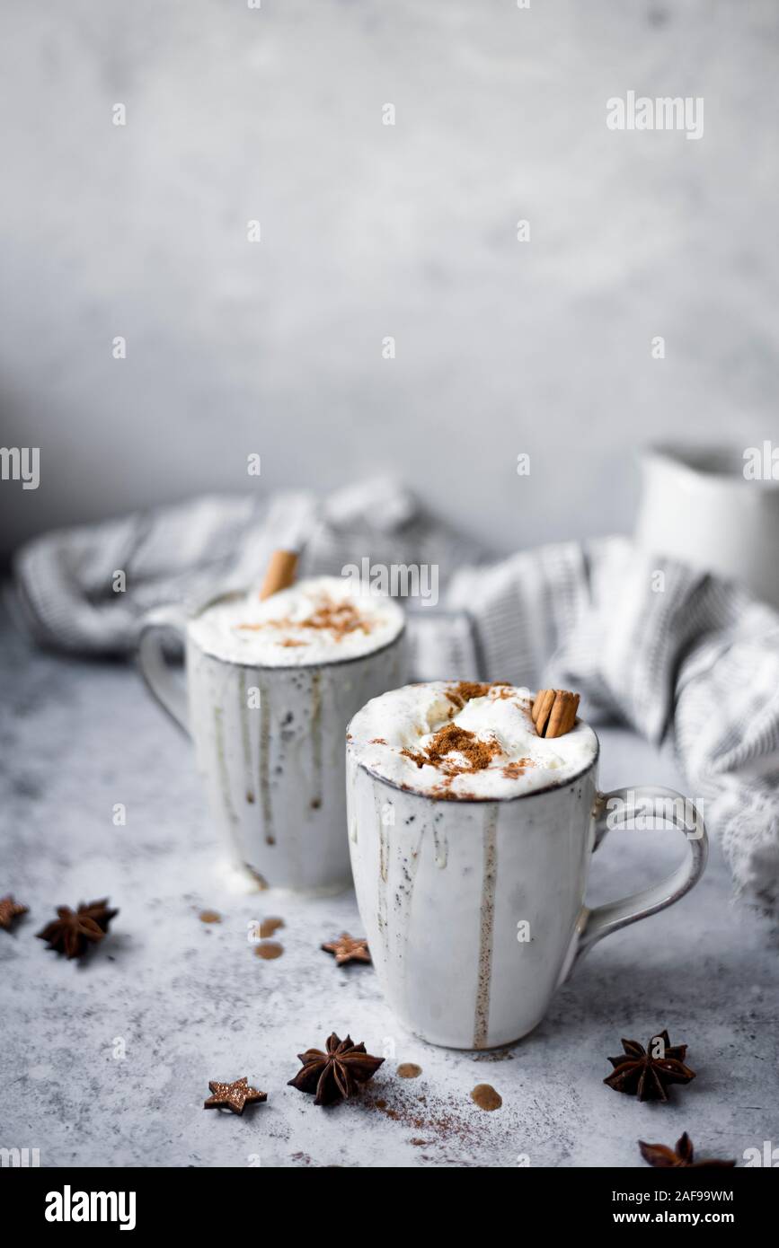 Pumpkin Spiced Latte With Whipped Cream Topping And Cinnamon Dusting Surrounded By Leaves And Spices Stock Photo