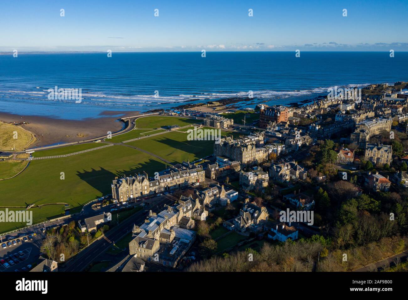 Aerial view of St Andrews from West Sands. The rocky coastline and the