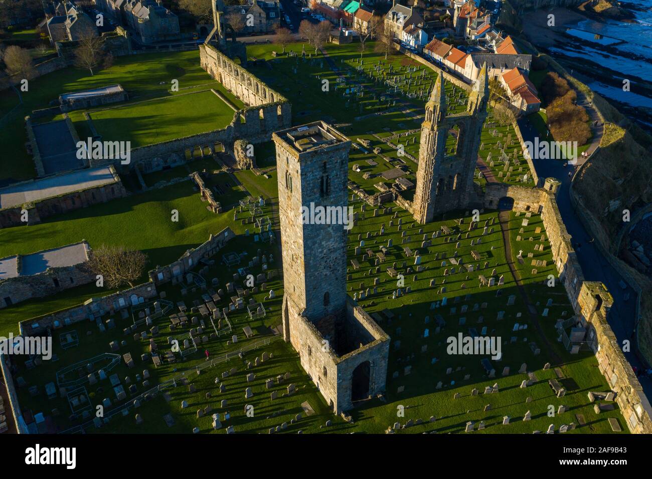 Unique Drone view of the ruins of the St Andrews Cathedral, Scotland with the dramatic coastline seen in the background. Stock Photo