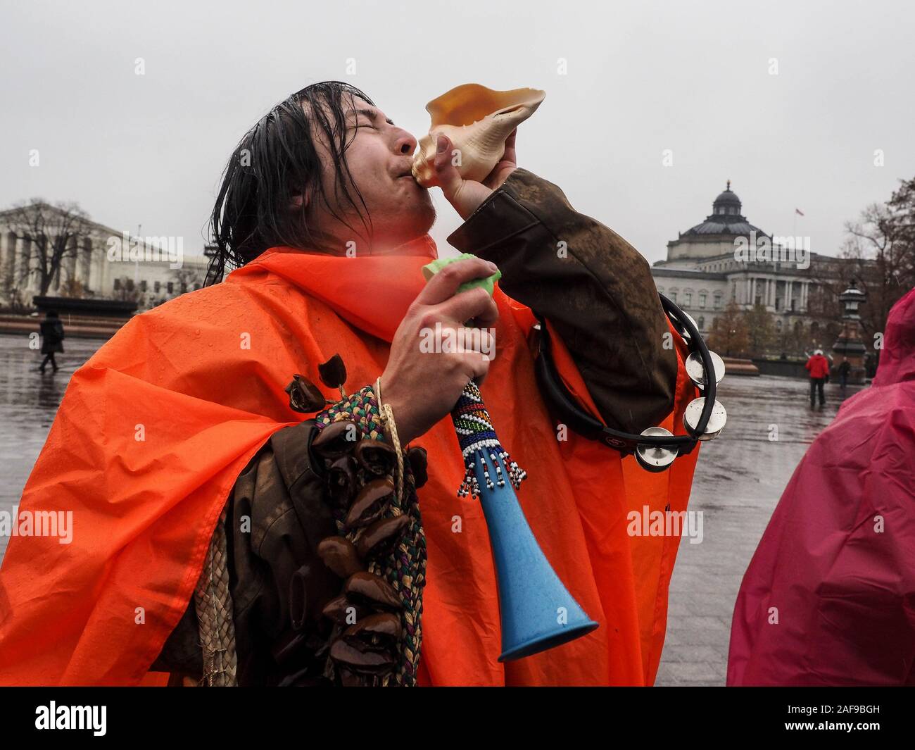 Washington, District of Columbia, USA. 13th Dec, 2019. Activist blows conch as a clarion call in support of the Fire Drill Fridays. Credit: Sue Dorfman/ZUMA Wire/Alamy Live News Stock Photo