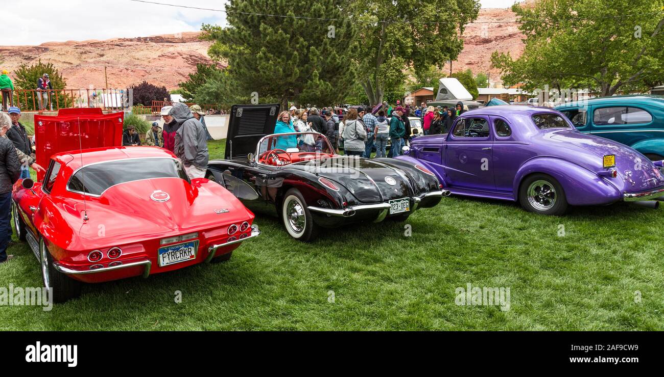 A restored and modified black 1958 Chevy Corvette in the Moab April Action Car Show in Moab, Utah.  At left is a 1976 Corvette Stingray.  At right is Stock Photo