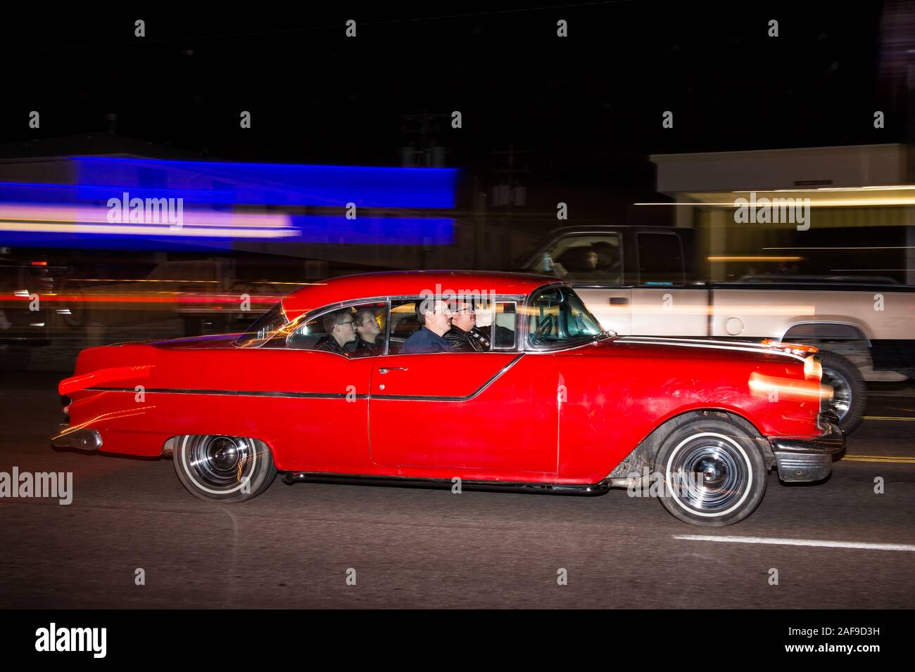 A restored 1955 Pontiac coupe cruising in the Moab April Action Car