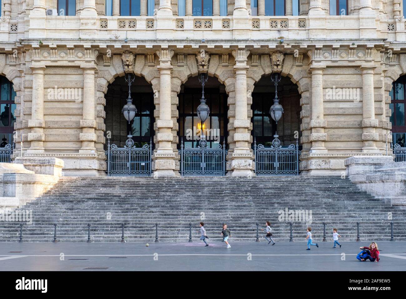 Children playing, front stairs of Corte Suprema di Cassazione (Supreme Court of Cassation), Palace of Justice, Rome, Italy Stock Photo