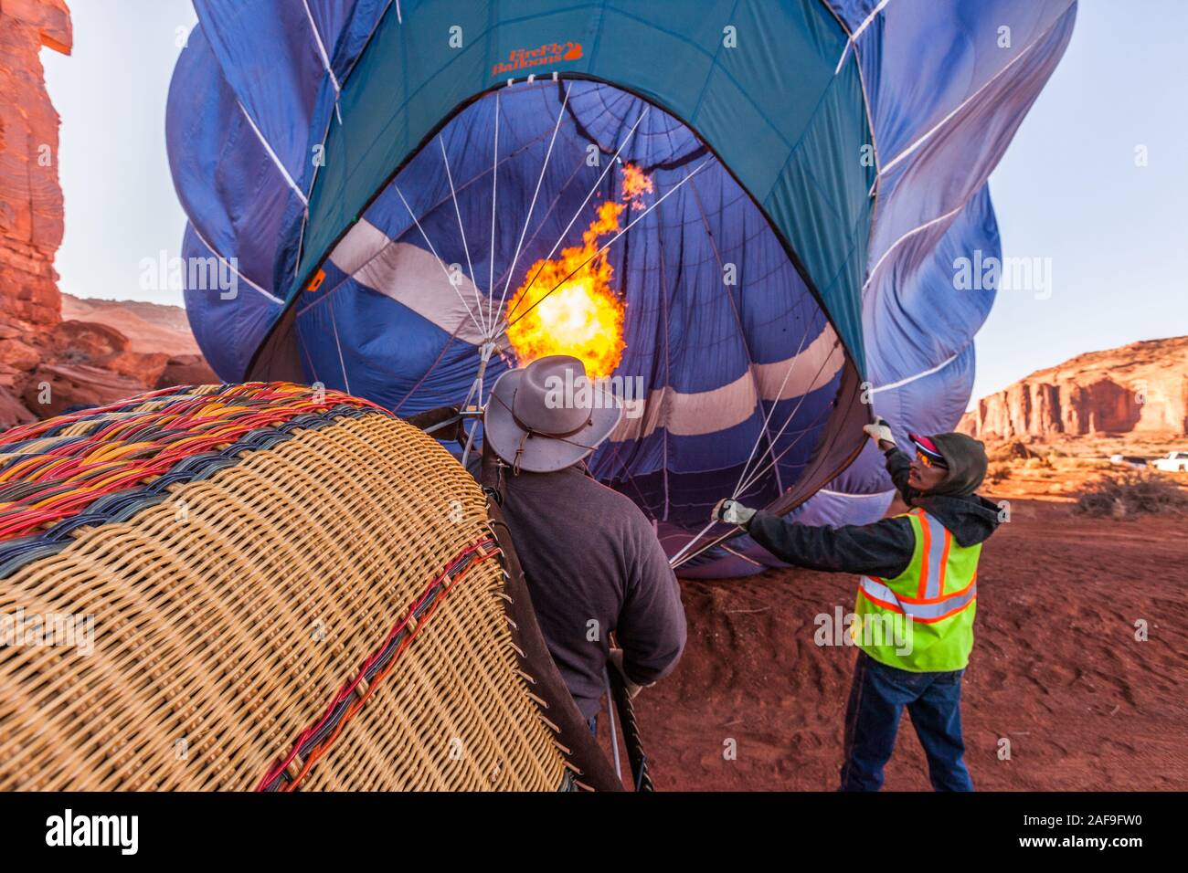 A hot air balloon fills with hot air from a buner in preparation for launch in the Monument Valley Balloon Festival in the Monument Valley Navajo Trib Stock Photo