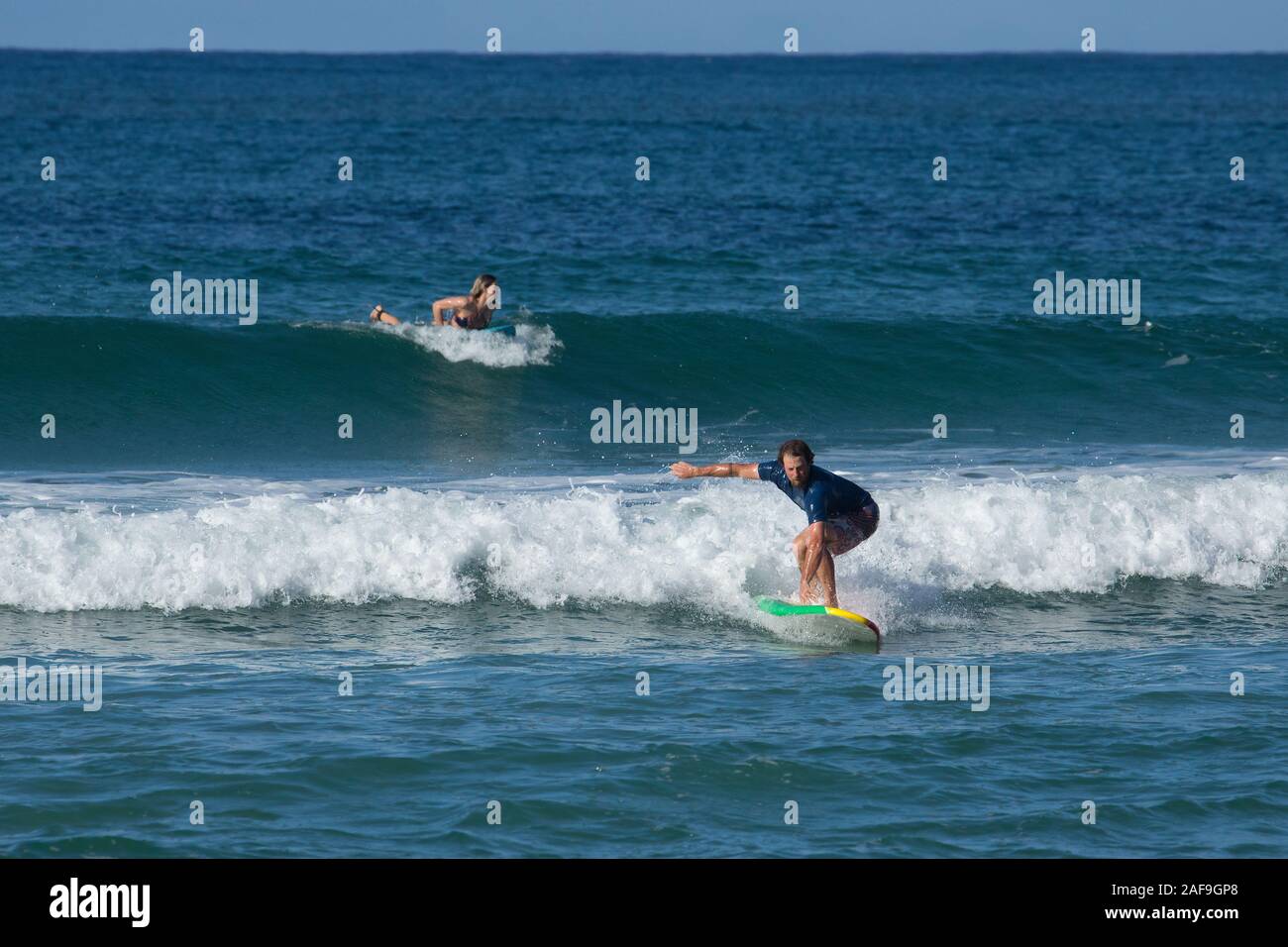 A tourist catches a wave surfing in Hanalei Bay, Kauai, Hawaii Stock Photo Alamy