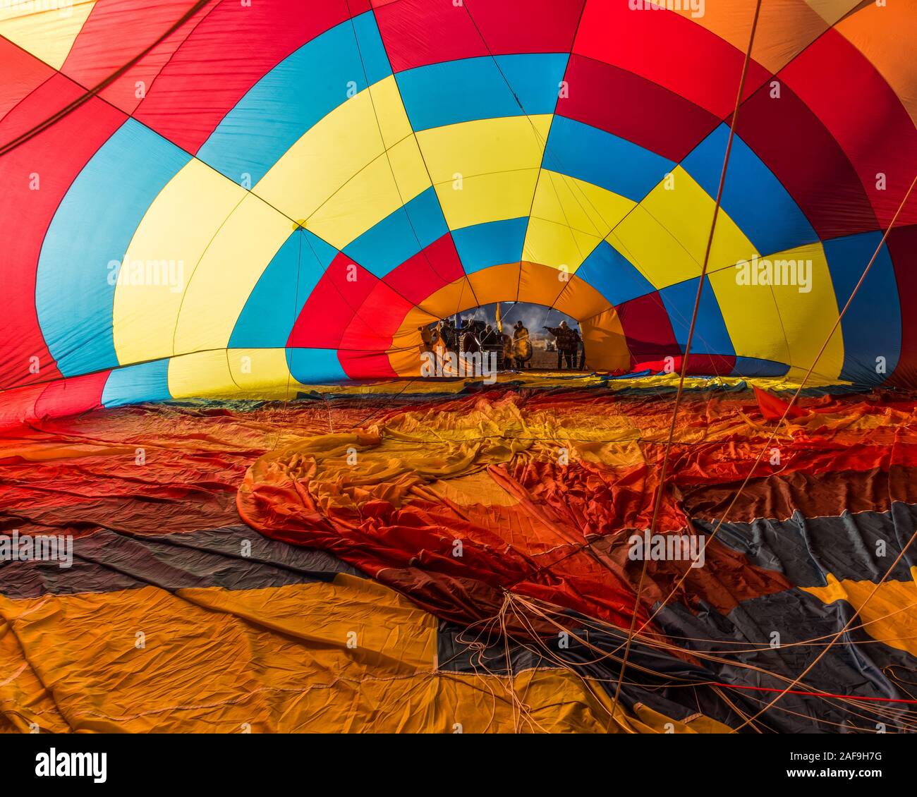 Flames from a propane burner fill the balloon with hot air in the ...
