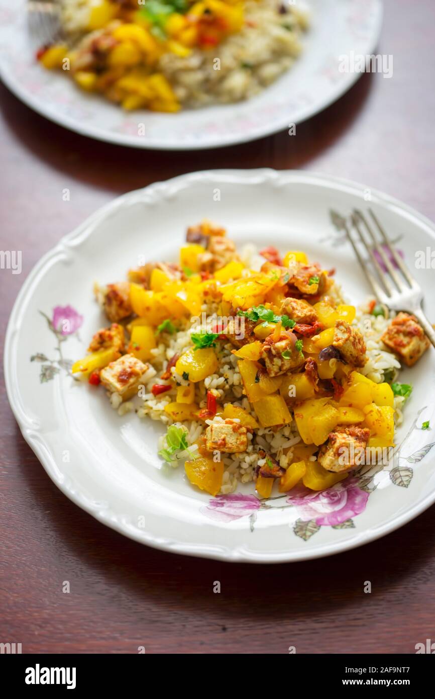 Tofu, yellow pepper, chilli tomato sauce with rice Stock Photo Alamy