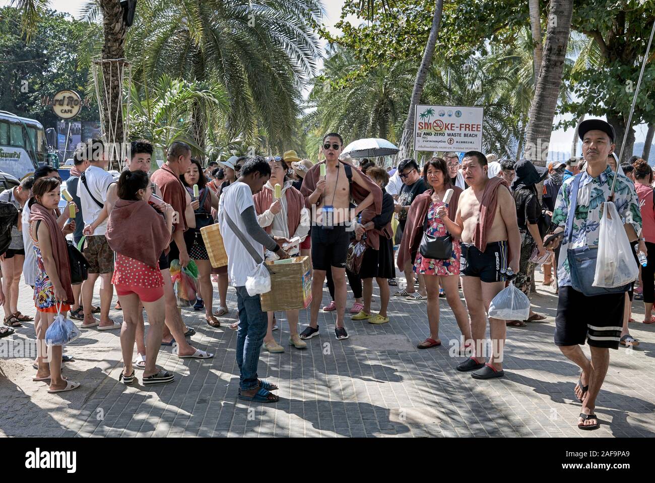 Chinese tourist group enjoying an ice lolly refreshment at Pattaya Thailand Stock Photo