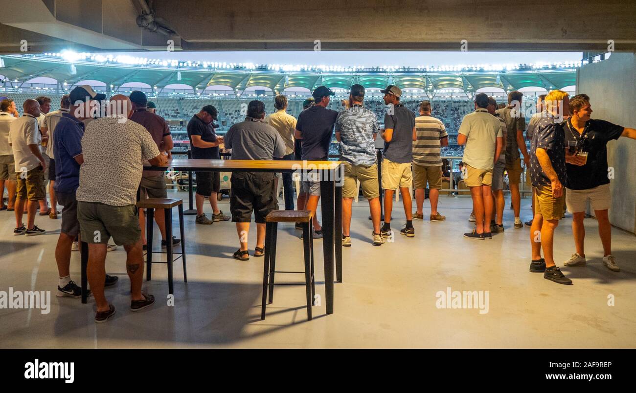 Male fans watching a cricket test match from a viewing platform at Optus Stadium Perth Western Australia. Stock Photo