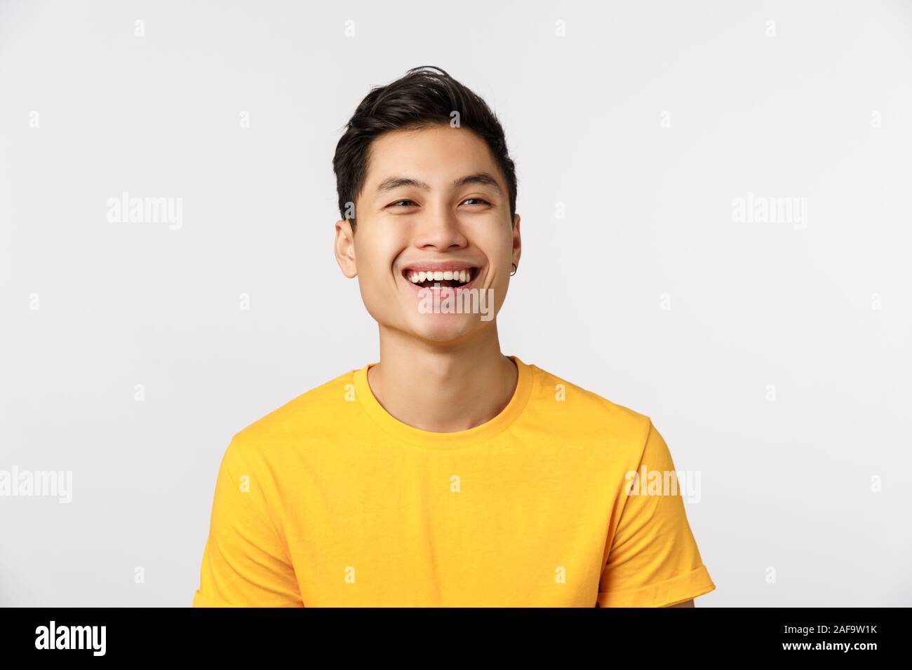 Friendship, joy and happiness concept. Cheerful young asian man in