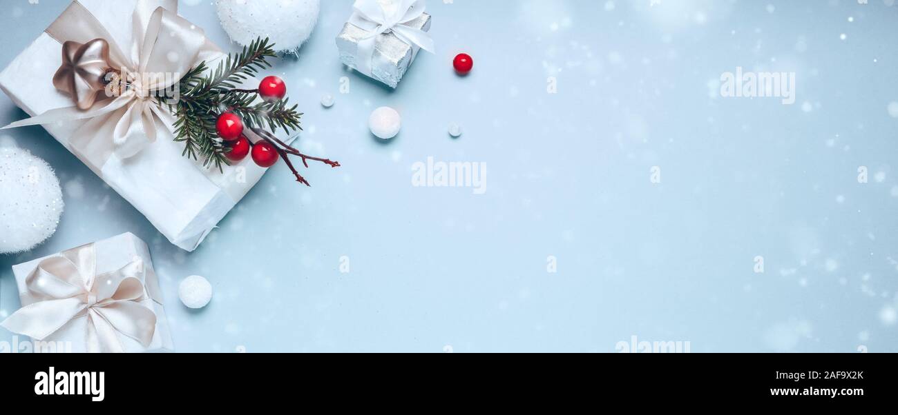 https://c8.alamy.com/comp/2AF9X2K/christmas-holiday-composition-white-gift-boxes-and-golden-christmas-toys-on-blue-background-flat-lay-copy-space-2AF9X2K.jpg
