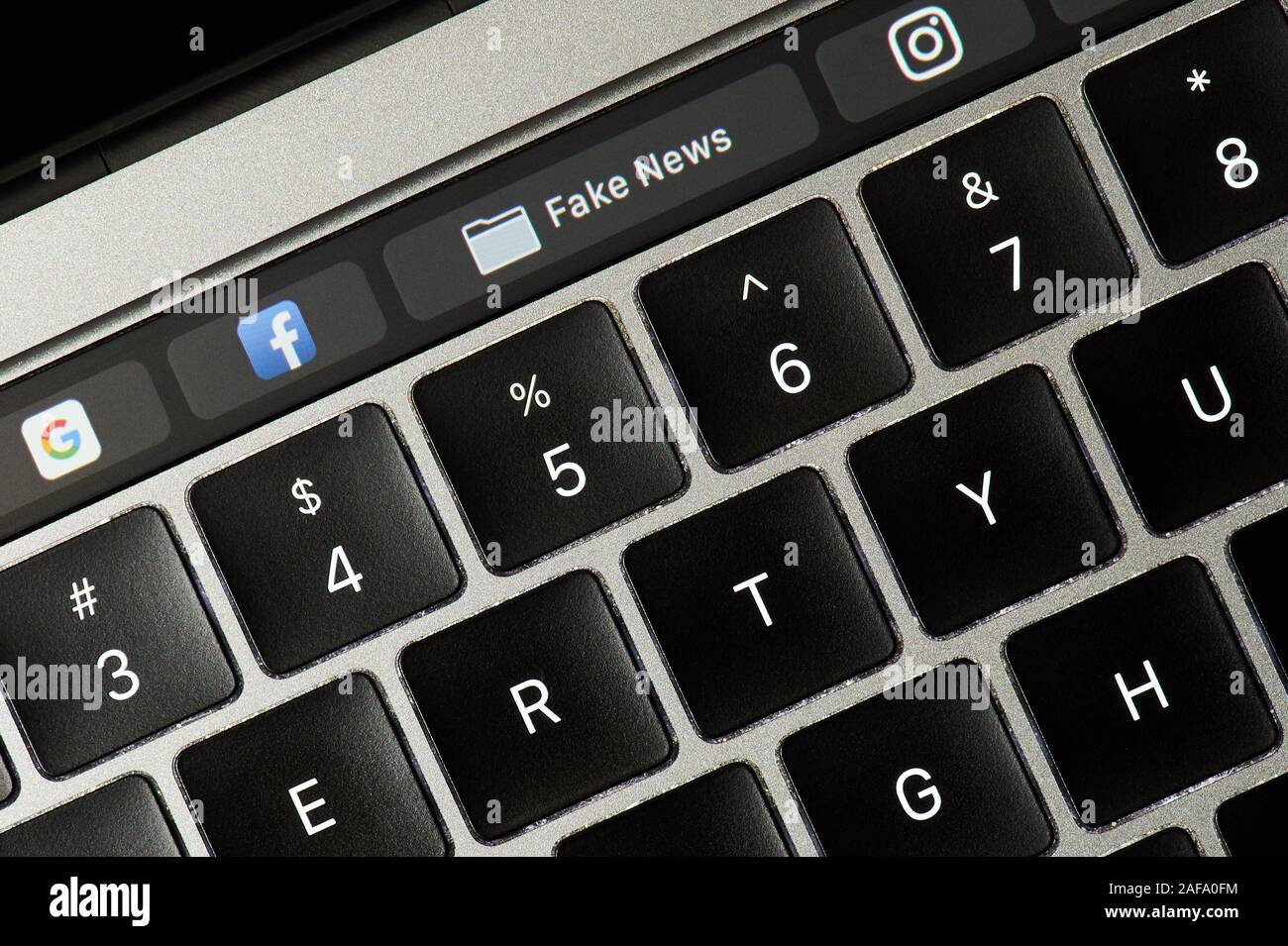 New york, USA - february 14, 2019: Fake news tab around social media on device screen pixelated close up view Stock Photo