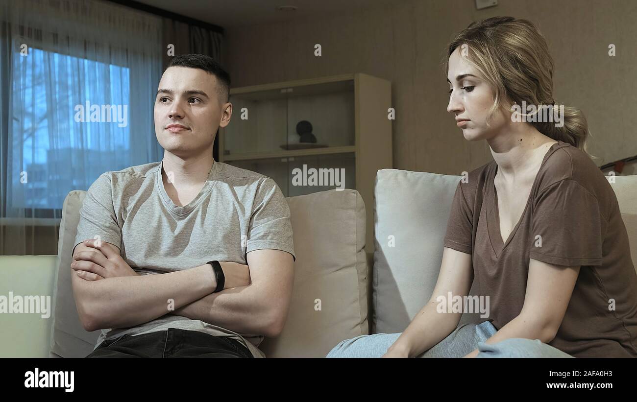 Frustrating couple at home sitting on a sofa Stock Photo