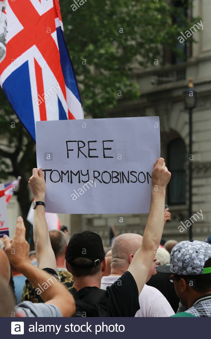 A free Tommy Robinson sign held aloft by a right-wing supporter Stock Photo