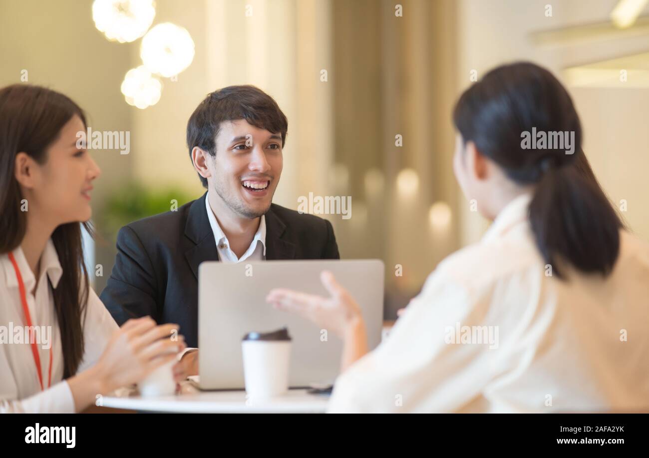 Young Asian woman and business people are meeting in office discussion ...
