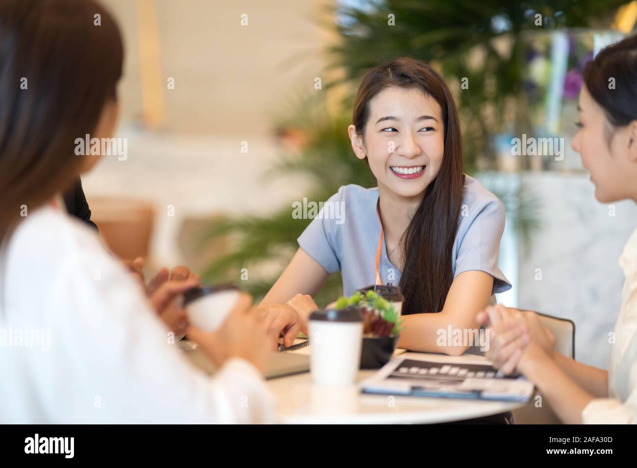 Young Asian woman and business people are meeting in office discussion ...