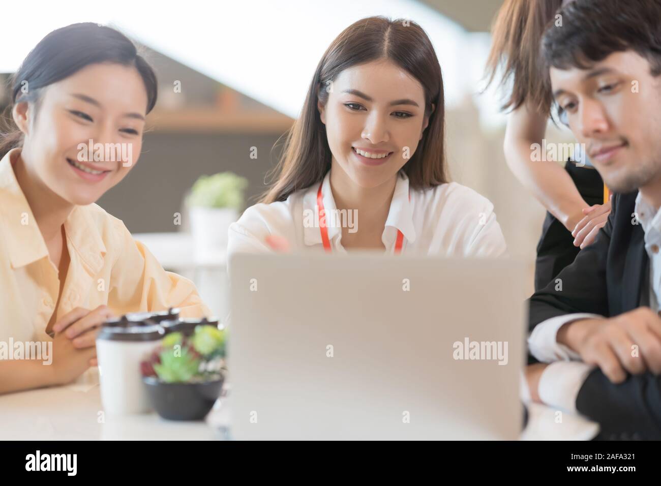 Young Asian woman and business people are meeting in office discussion ...